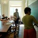 A student writes on a chalk board inside of a St John's College classroom